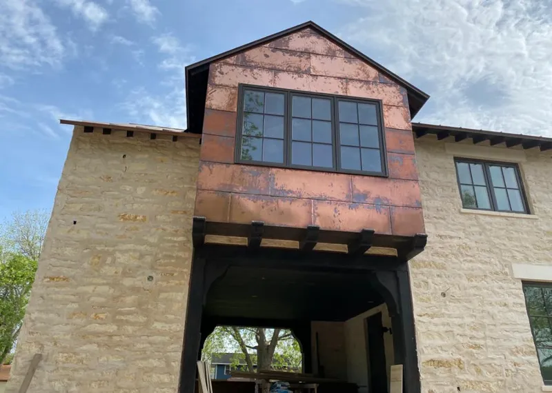 Copper metal panel facade on a stone building for Roof Repair in North Fort Myers